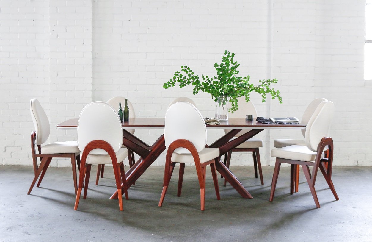 The Castellane table set for eight, with the matching arched-back dining chairs
