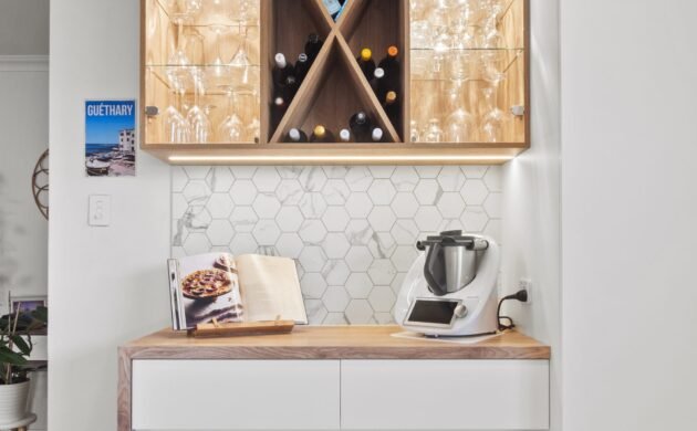 The bar nook: cross wine rack with lit glass shelves over a white cabinet with a timber top