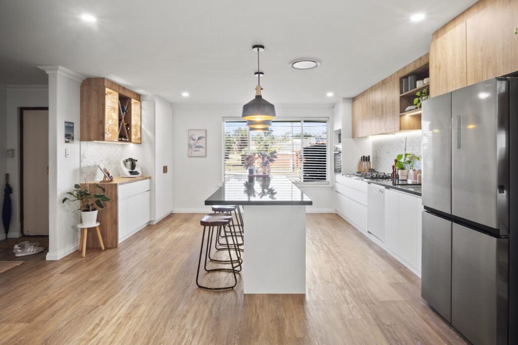 From the front door: the bar nook on the left, the island in the middle, the cooking run and fridge on the right